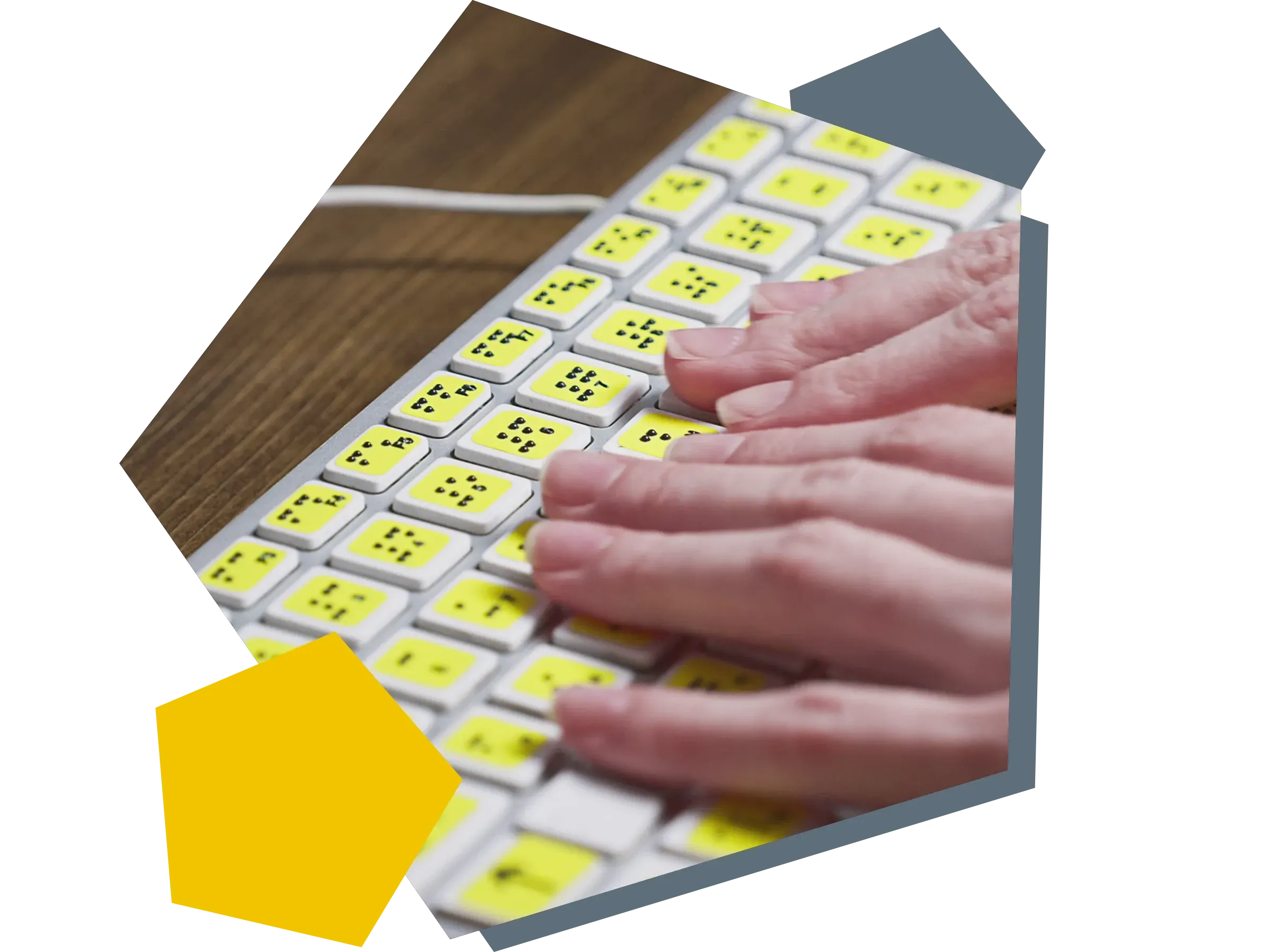 Two hands on a keyboard with key labelling for visually impaired People